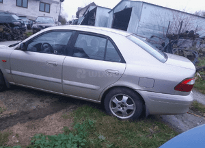Mazda 626 GF GW 97-02 LIFT    Maska lampa zderzak pas atrapa zamek mocowanie  kolor 4F 7