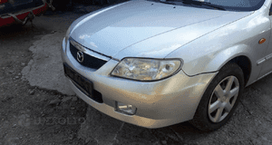 Mazda 323 323f BJ 98-00  Maska lampa zderzak pas atrapa 22V 9