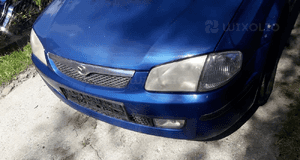 Mazda 323 323f BJ 98-00  Maska lampa zderzak pas atrapa 22V 6