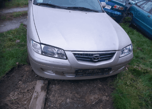 Mazda 626 GF GW 97-02 LIFT    Maska lampa zderzak pas atrapa zamek mocowanie  kolor 4F 3